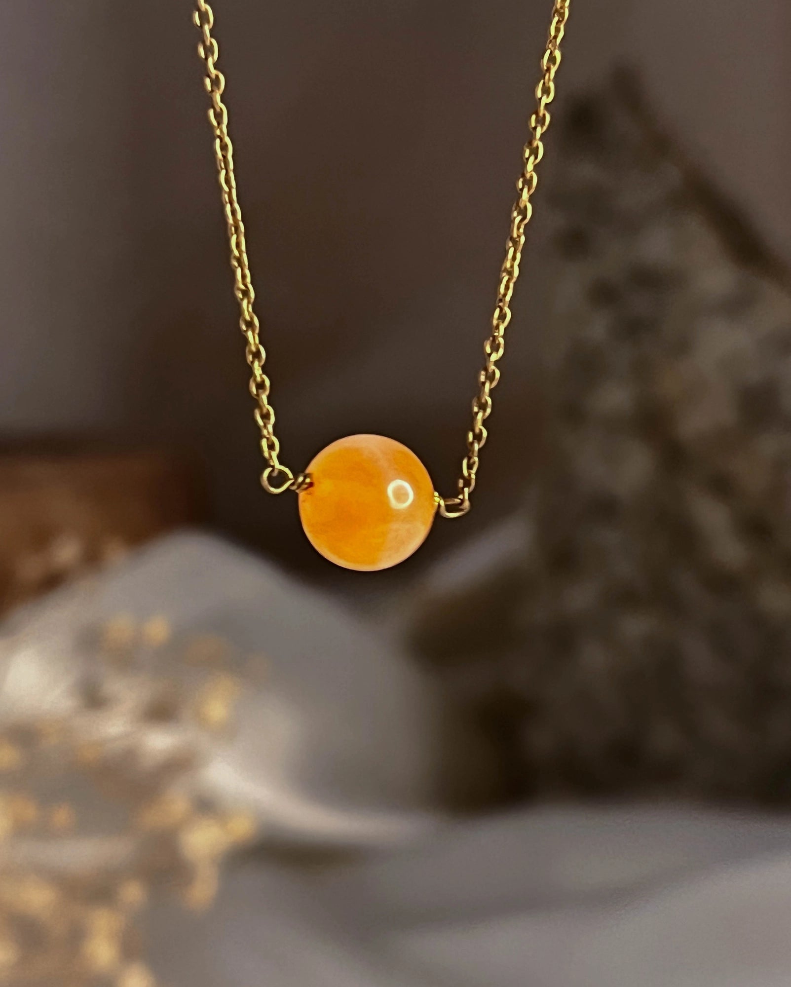 Brass necklace with orange Carnelian crystal bead in the centre handmade by A Creator's Studio