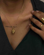 Brass necklace with a coffee bean pendant handmade by A Creator's Studio