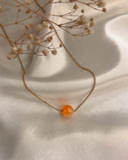 Brass necklace with orange Carnelian crystal bead in the centre handmade by A Creator's Studio