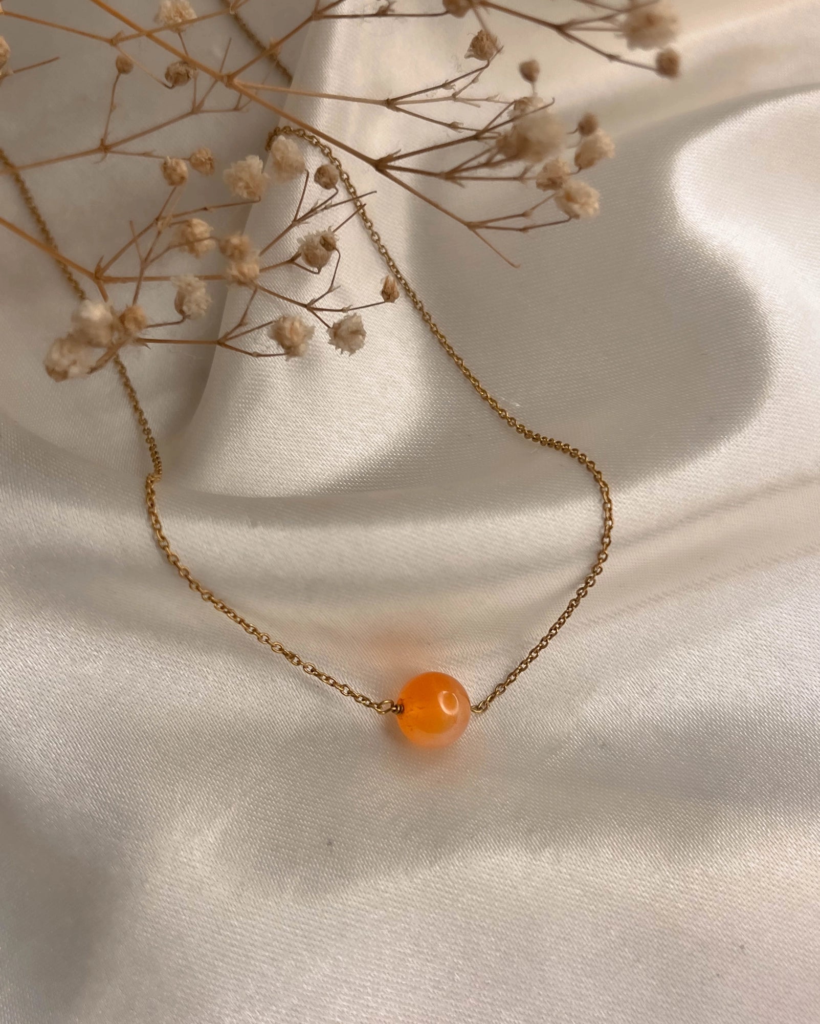 Brass necklace with orange Carnelian crystal bead in the centre handmade by A Creator's Studio