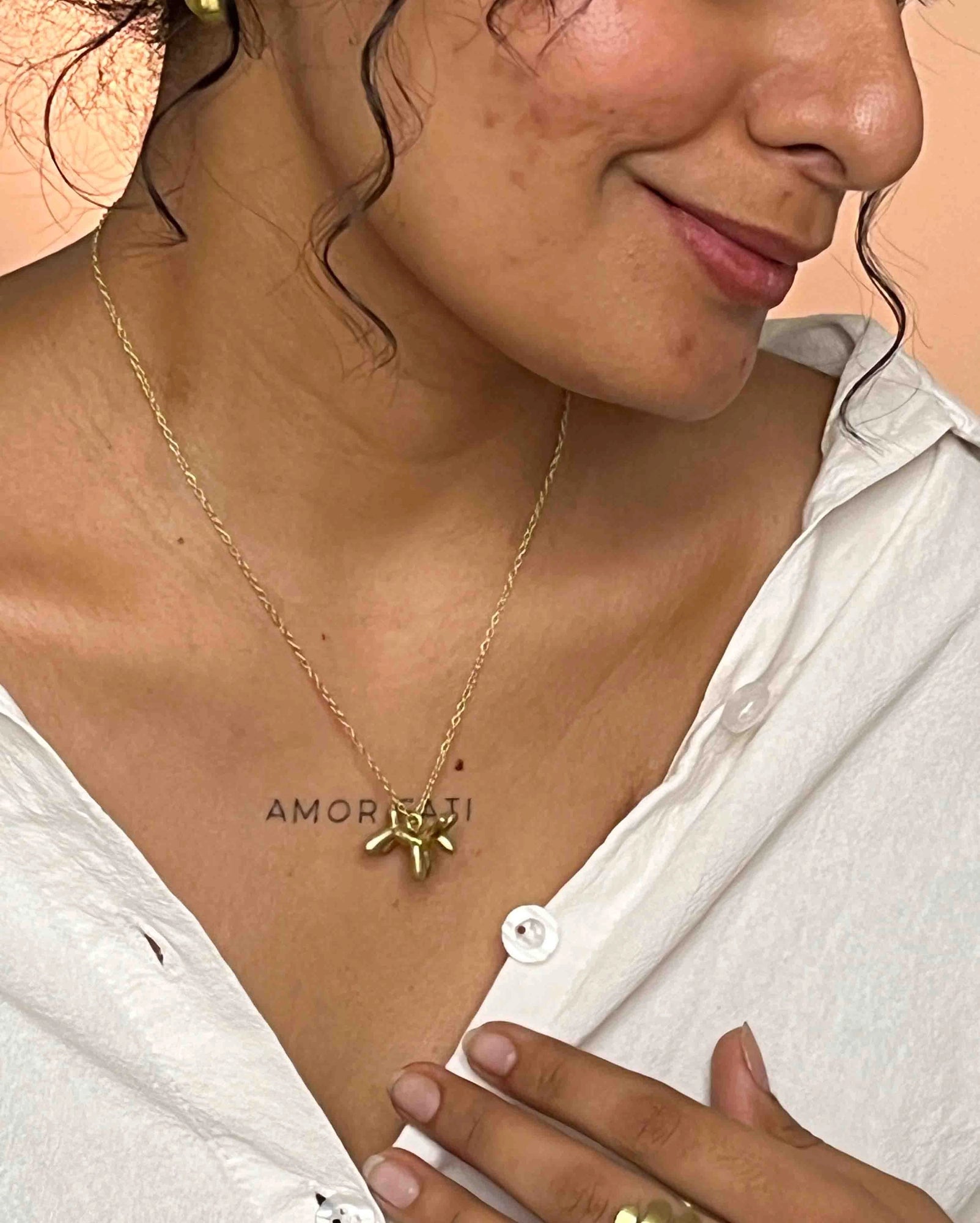 Brass necklace with a balloon dog pendant handmade by A Creator's Studio