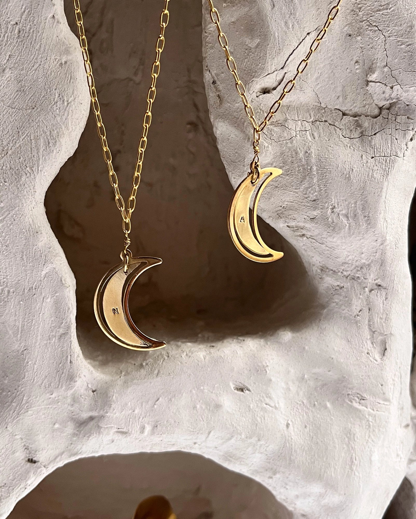 Brass necklace with a swinging and engraved crescent moon pendant handmade by A Creator's Studio