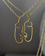 a set of two Brass wired face necklaces with chain handmade by A Creator's Studio