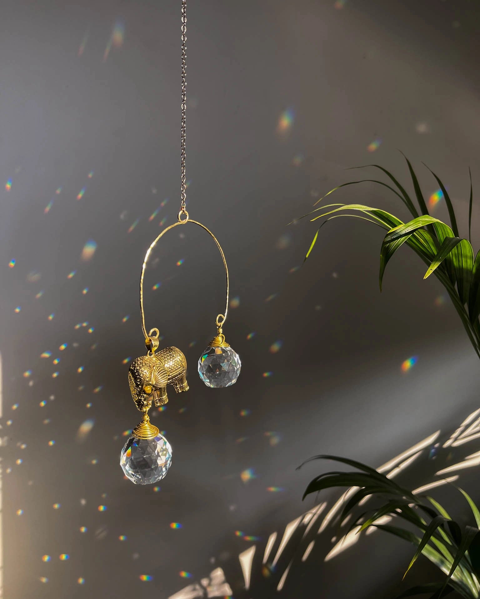 Elephant sun catcher with glass crystal drops and a tiger eye gemstone, handmade by A Creator's Studio