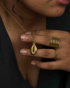 Brass necklace with a coffee bean pendant handmade by A Creator's Studio