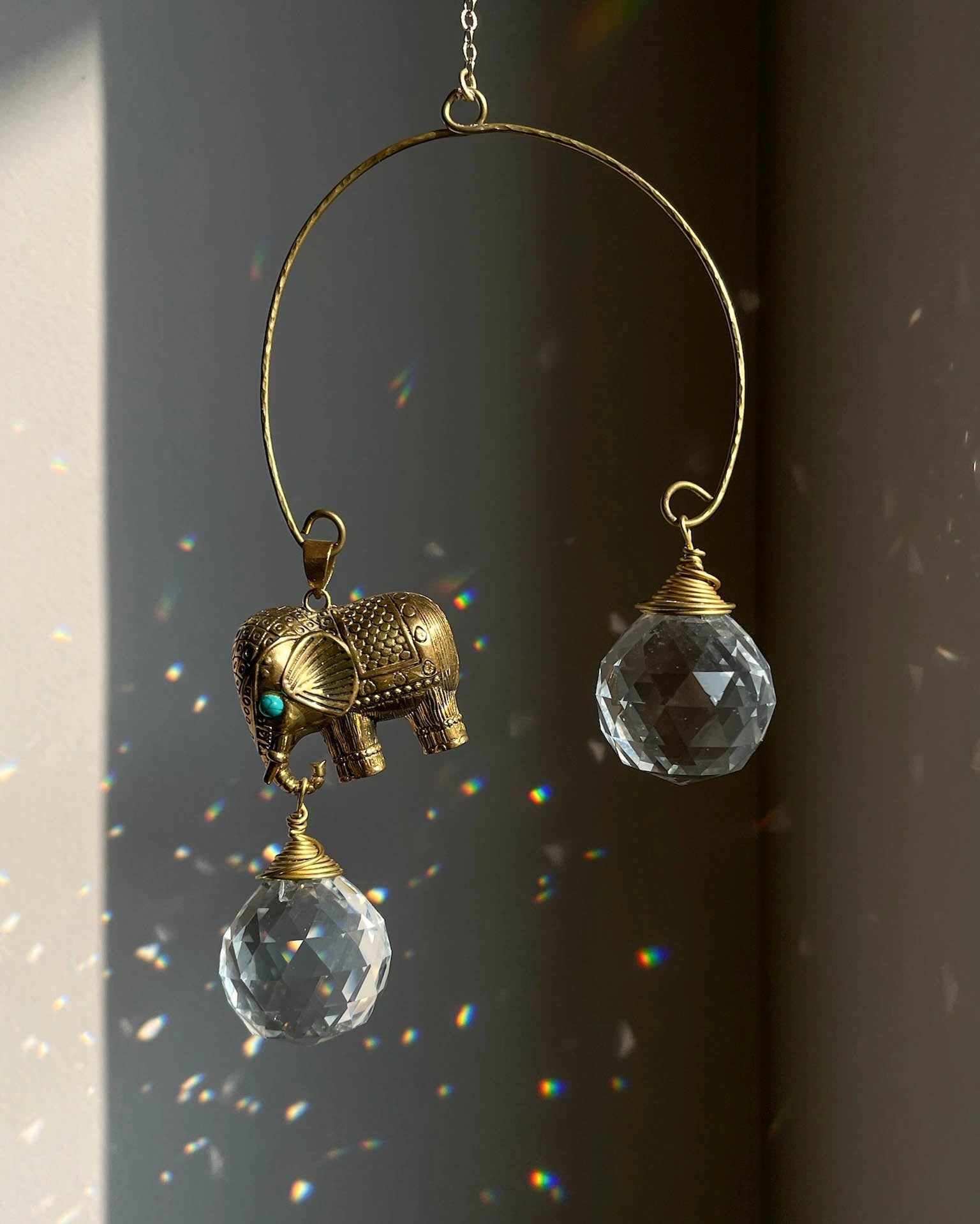 Elephant sun catcher with glass crystal drops and a turquoise gemstone, handmade by A Creator's Studio