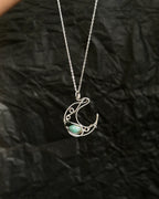 Sterling Silver Necklace with a wire wrapped moon pendant and an emerald gemstone handmade by A Creator's Studio