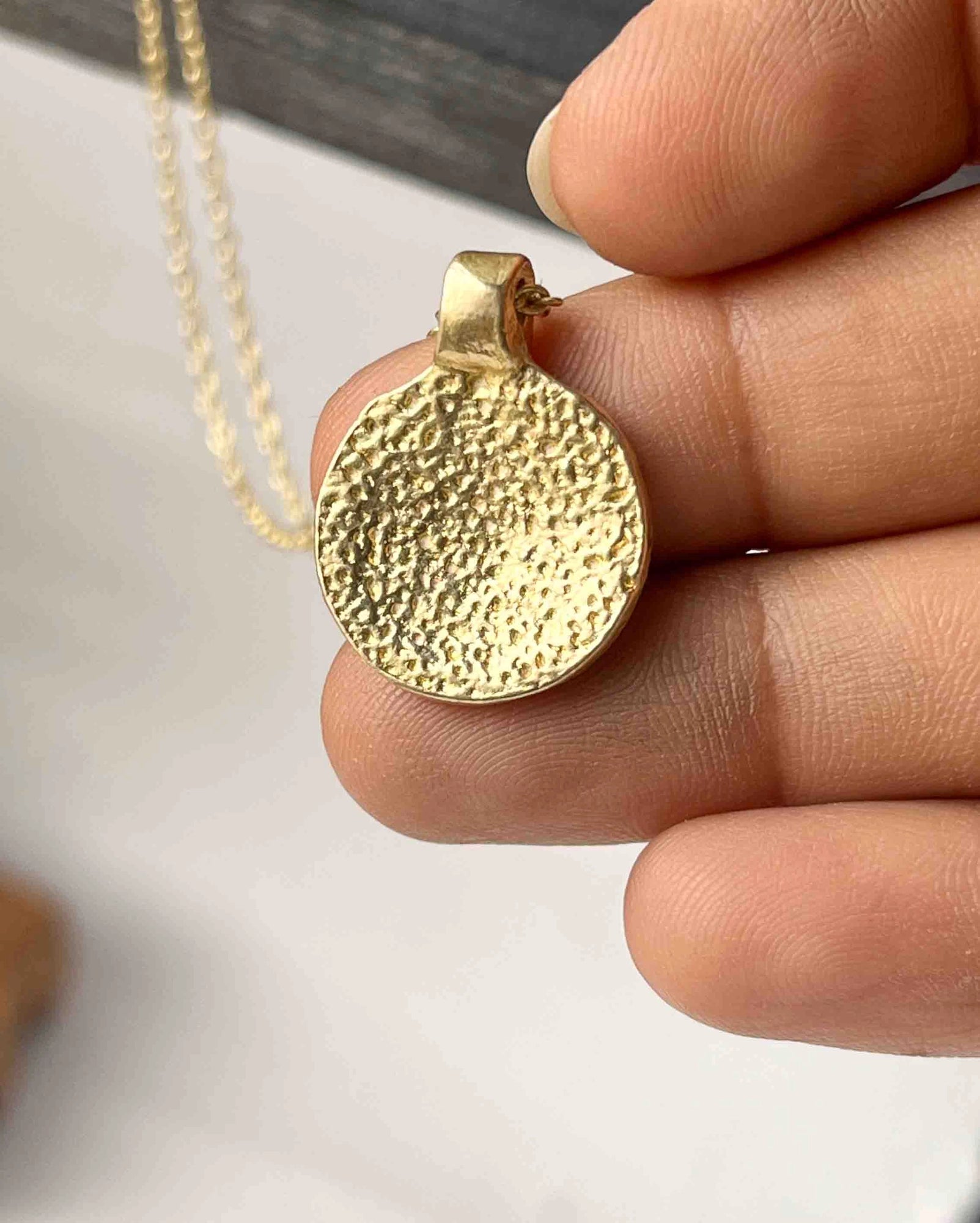 Brass necklace with a hammer texture coin pendant handmade by A Creator's Studio