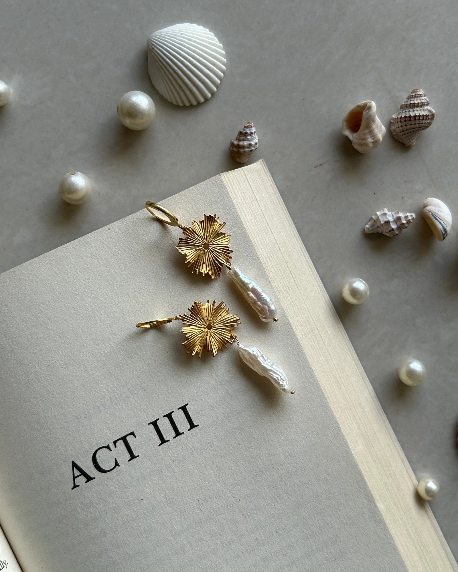 Gold plated dangle earrings with a flower charm and a freshwater pearl drop handmade by A Creator's Studio