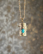 Brass box (dibbi) pendant with a turquoise in the centre with a chain handmade by A Creator's Studio