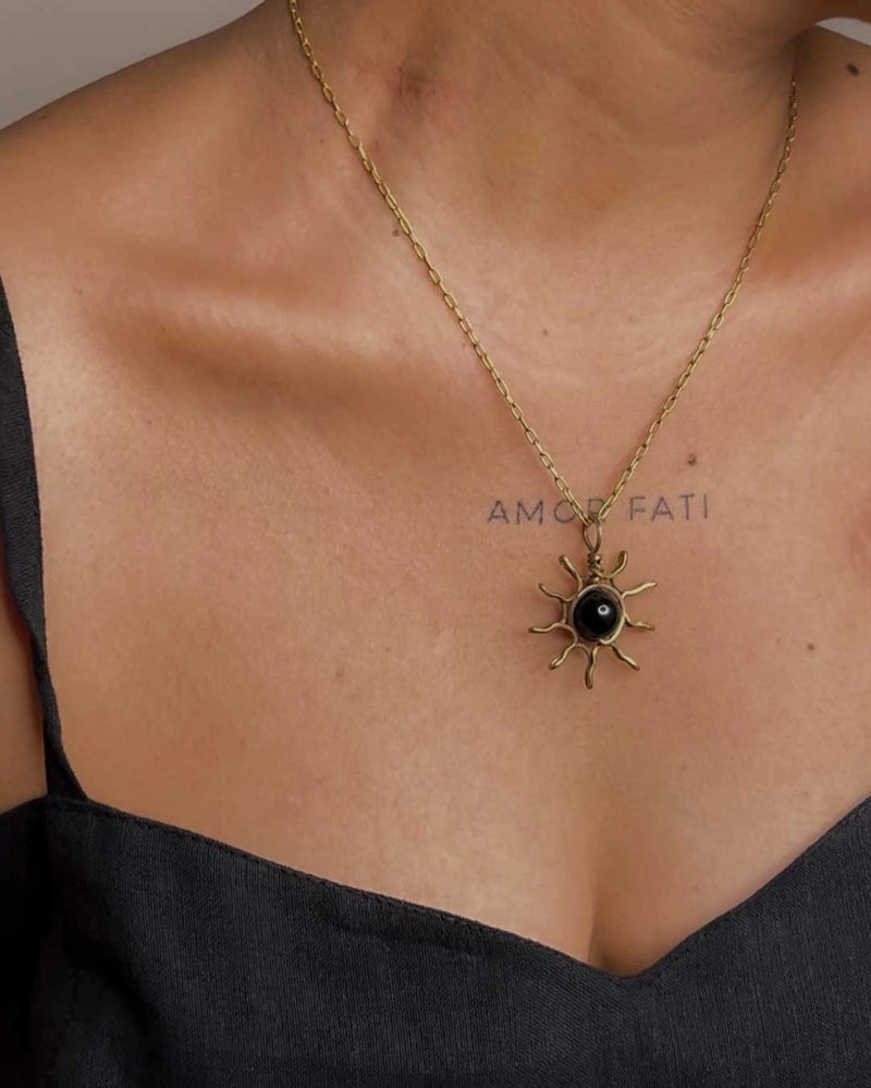 Brass wired sun necklace with a crystal in the centre handmade by A Creator's Studio