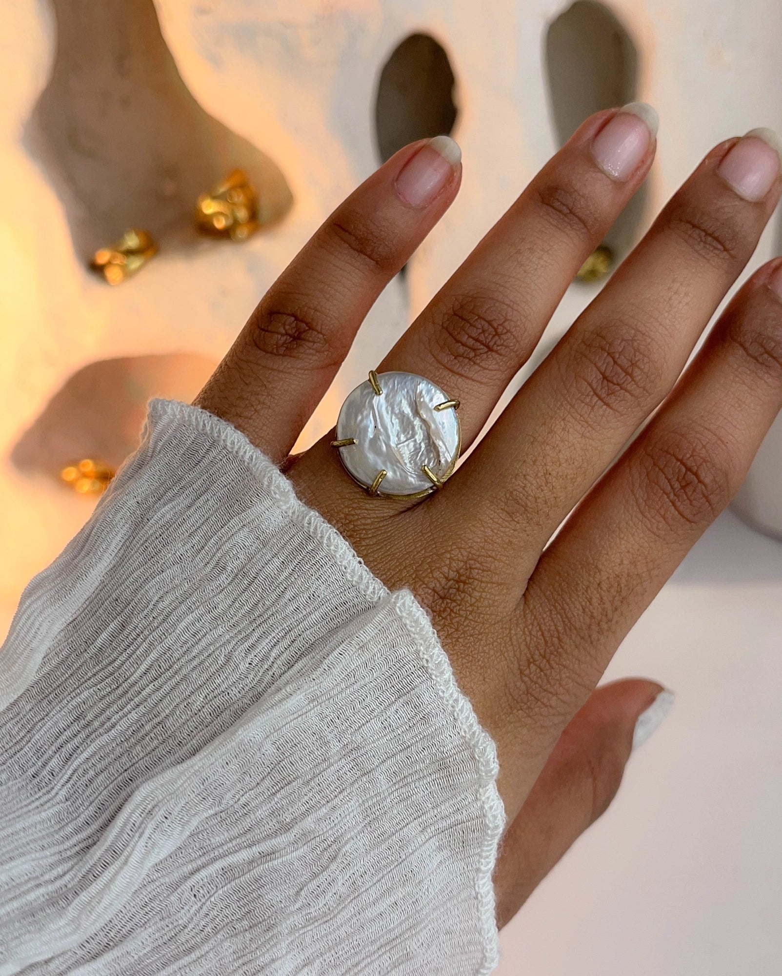 A pearl coin ring in prong setting in brass handmade by a creator's studio