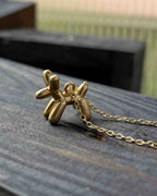 Brass necklace with a balloon dog pendant handmade by A Creator's Studio