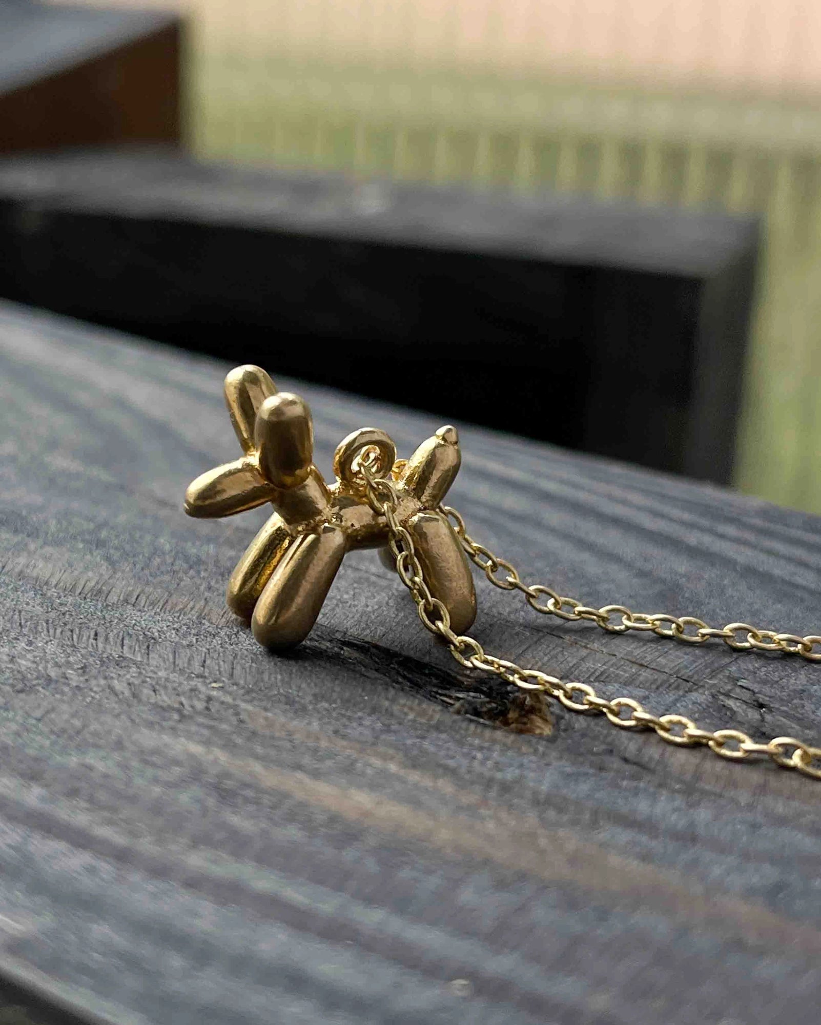 Brass necklace with a balloon dog pendant handmade by A Creator's Studio