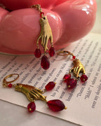 Brass necklace with a hand pendant and red crystal drops and matching earrings handmade by A Creator's Studio