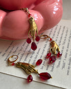 Brass necklace with a hand pendant and red crystal drops handmade by A Creator's Studio