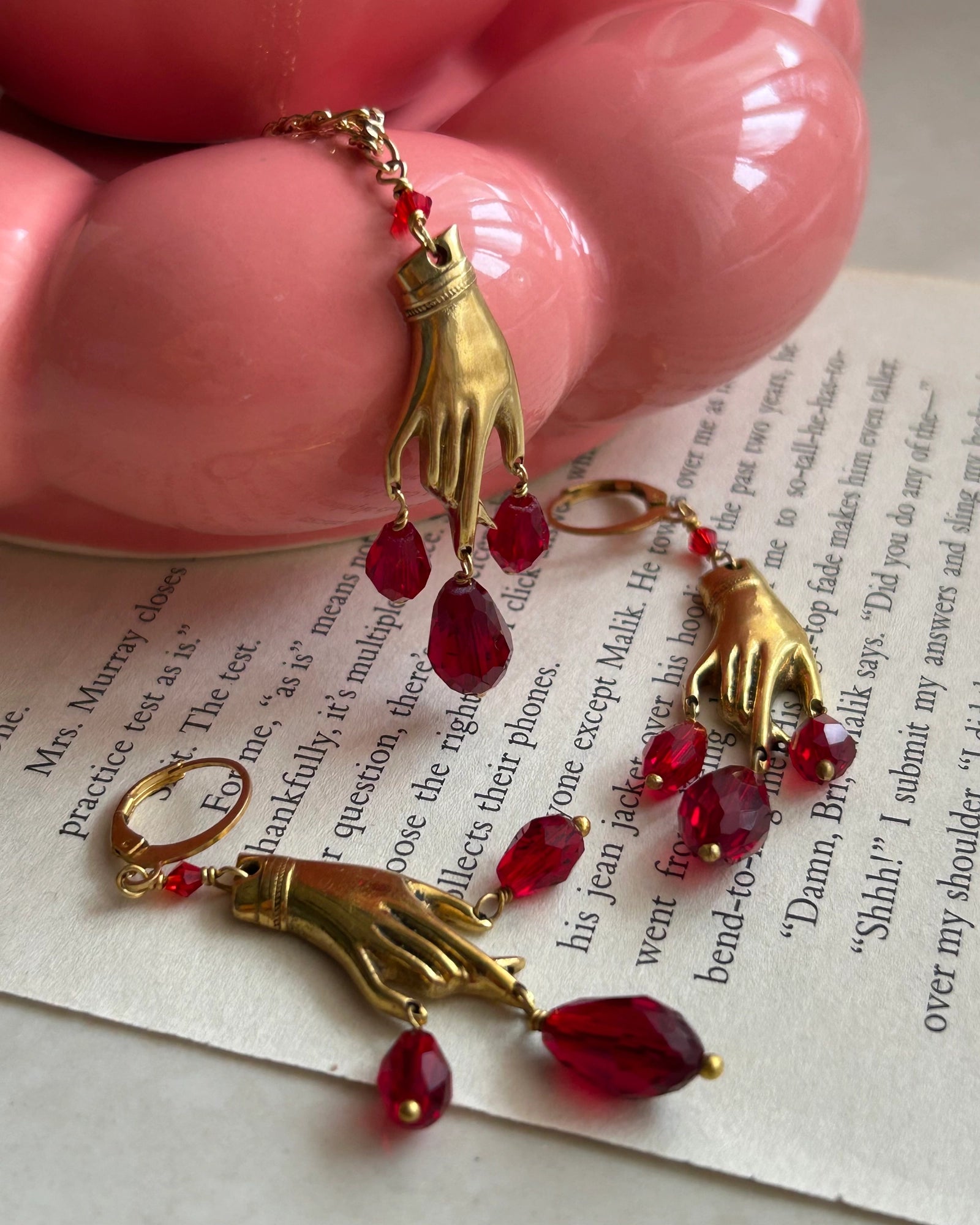 Brass necklace with a hand pendant and red crystal drops handmade by A Creator's Studio