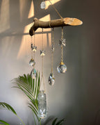 upcycled sun catcher with glass crystals, a wooden log base and a geode handmade by A Creator's Studio