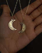 Brass necklace with a swinging and engraved crescent moon pendant handmade by A Creator's Studio