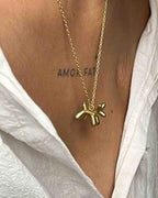 Brass necklace with a balloon dog pendant handmade by A Creator's Studio