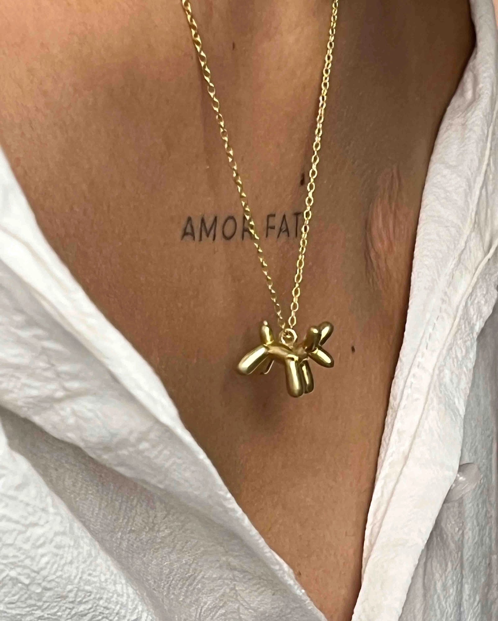 Brass necklace with a balloon dog pendant handmade by A Creator's Studio