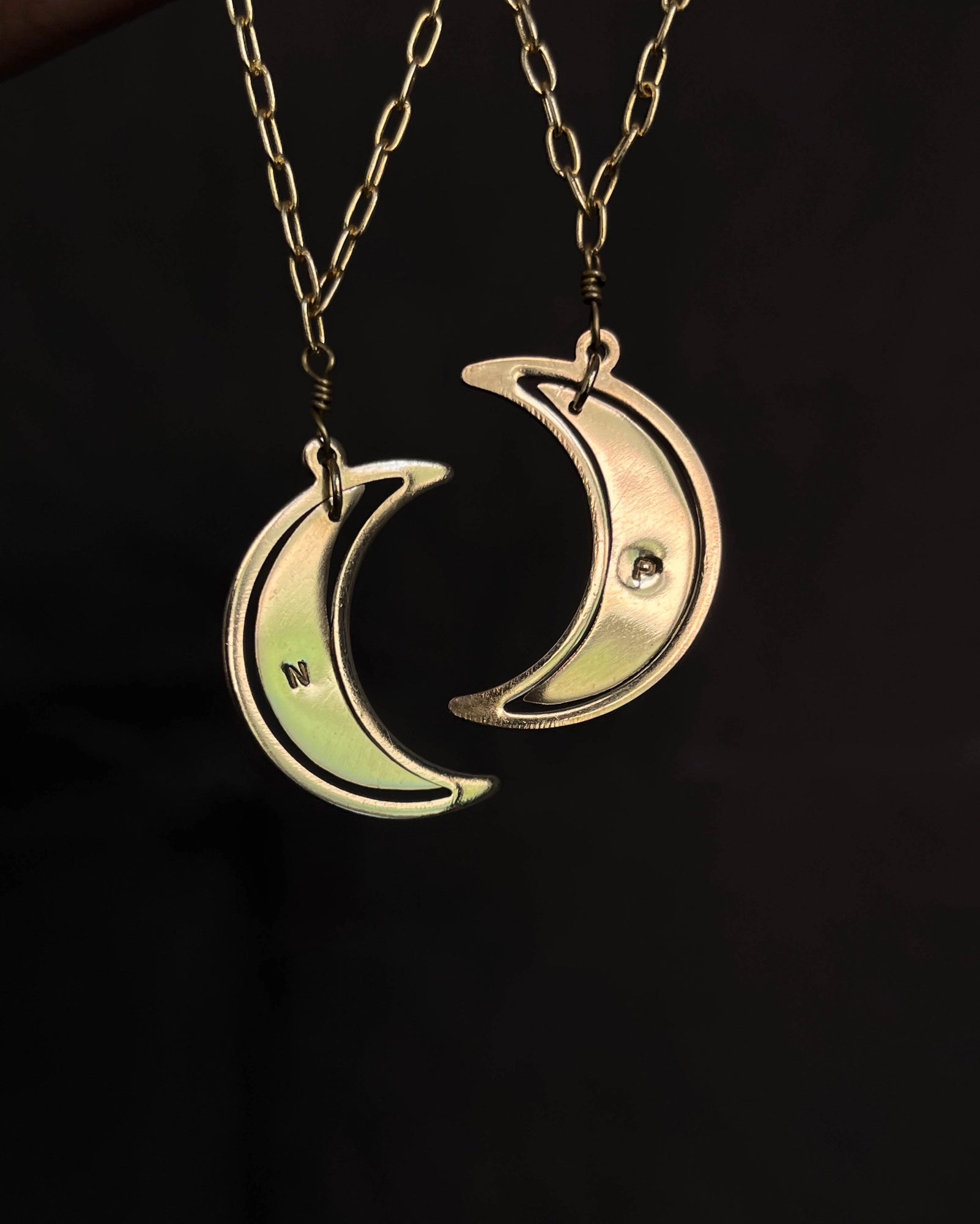 Brass necklace with a swinging and engraved crescent moon pendant handmade by A Creator's Studio
