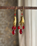 Brass necklace with a hand pendant and red crystal drops and matching earrings handmade by A Creator's Studio
