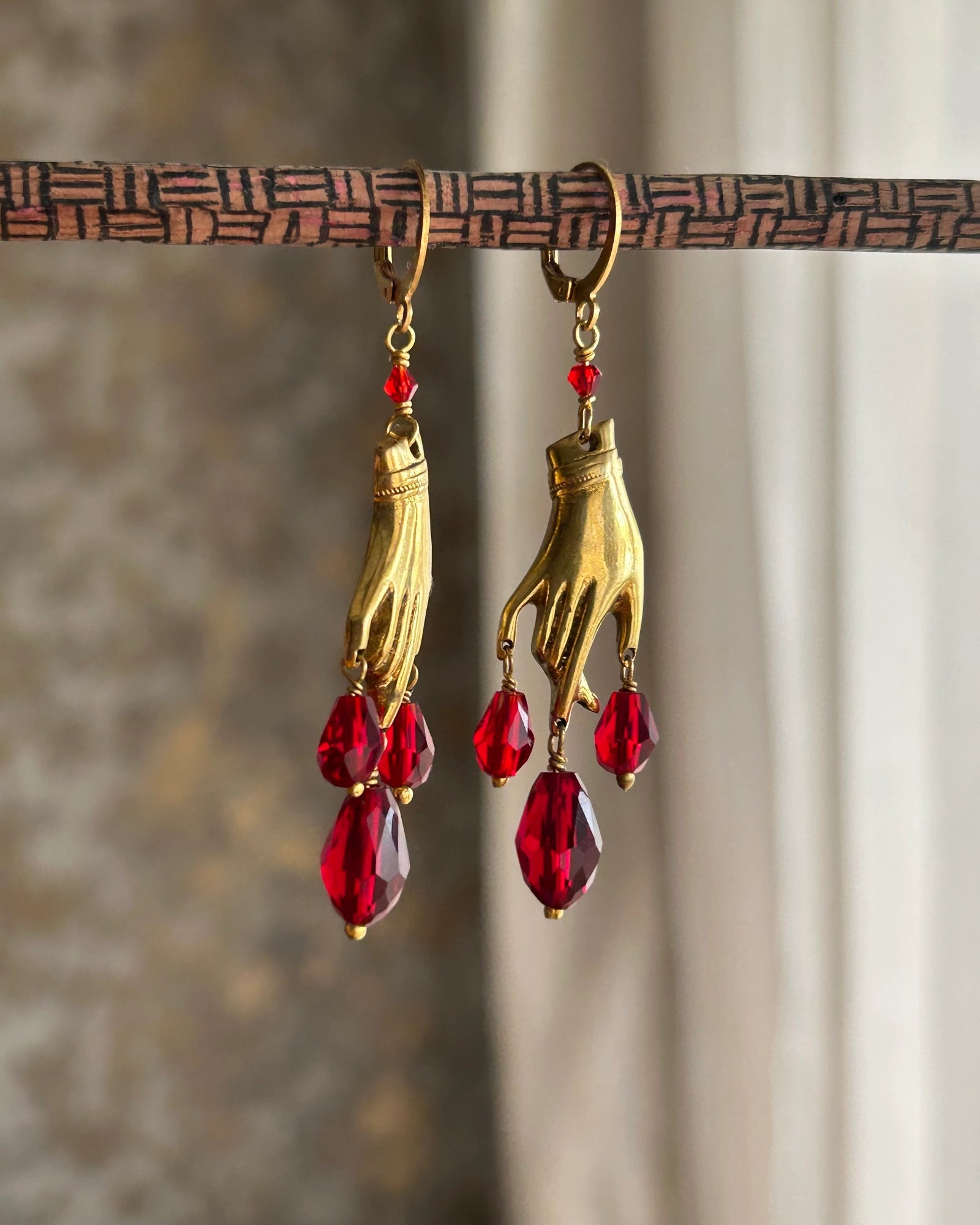 Brass necklace with a hand pendant and red crystal drops and matching earrings handmade by A Creator's Studio