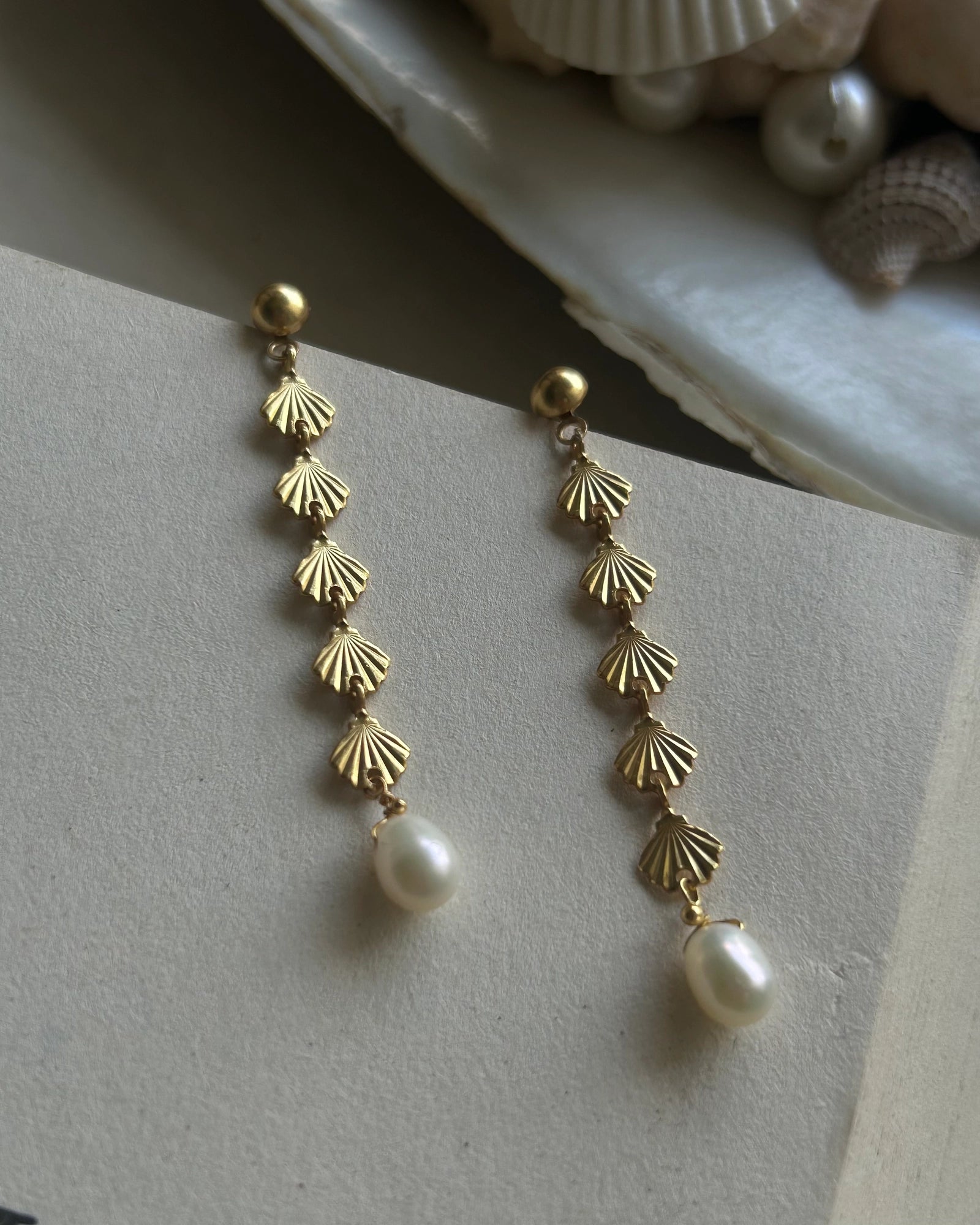 Gold Plated seashell dangle earrings with a fresh water pearl drop handmade by A Creator's Studio