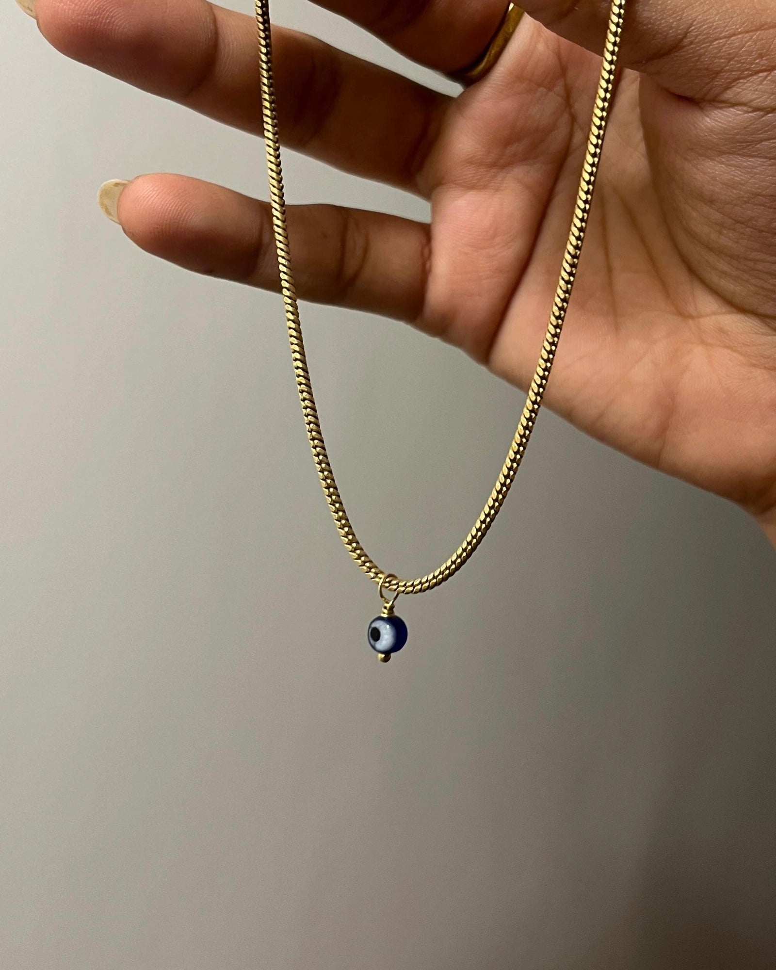 Brass evil eye anklet with an evil eye bead drop handmade by A Creator's Studio