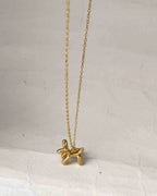 Brass necklace with a balloon dog pendant handmade by A Creator's Studio