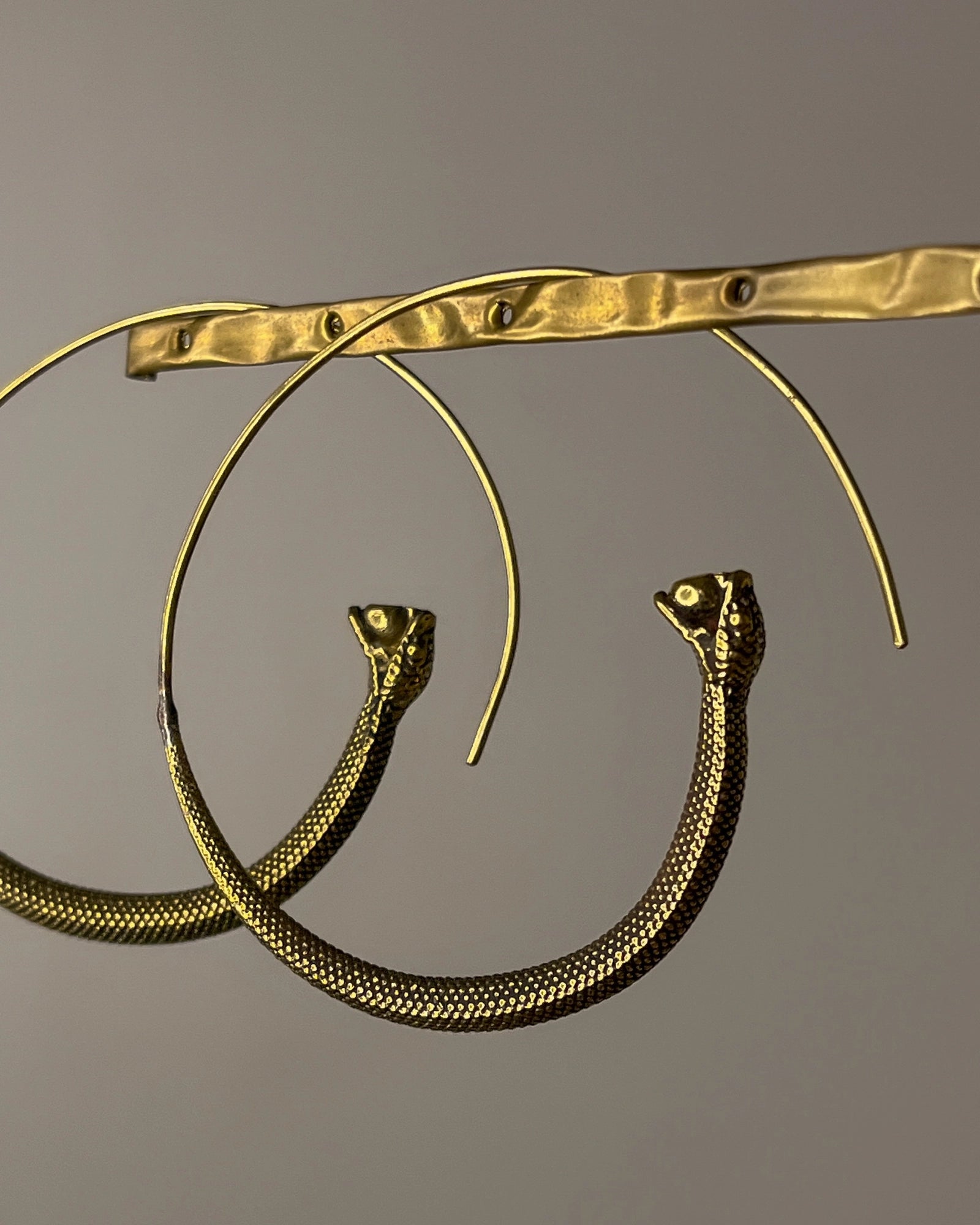 Brass snake hoop earrings handmade by A Creator's Studio