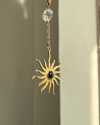 Brass sun-shaped car charm with a central gemstone handmade by A Creator's Studio