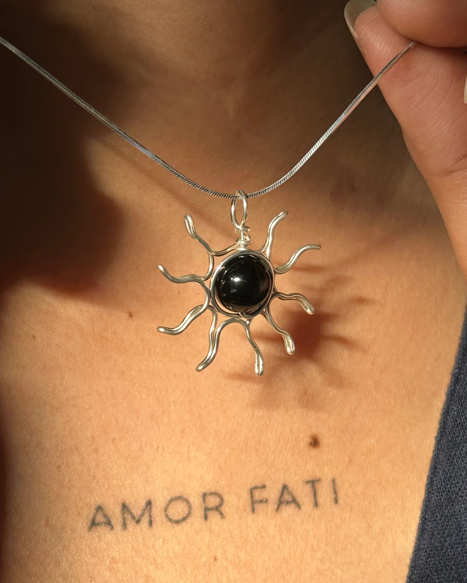 Sterling Silver Necklace with a wire wrapped sun pendant with a black onyx gemstone handmade by A Creator's Studio
