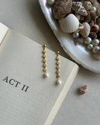 Gold Plated seashell dangle earrings with a fresh water pearl drop handmade by A Creator's Studio