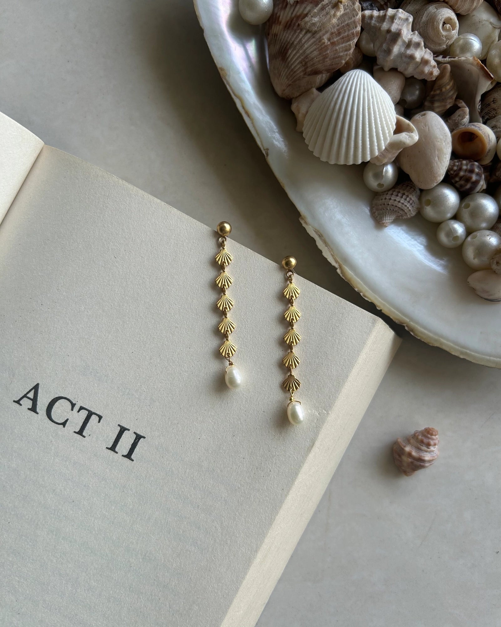 Gold Plated seashell dangle earrings with a fresh water pearl drop handmade by A Creator's Studio