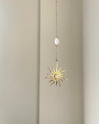 Brass sun-shaped car charm with a central gemstone handmade by A Creator's Studio