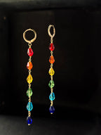 Rainbow-colored drop earrings handmade by a creator's studio