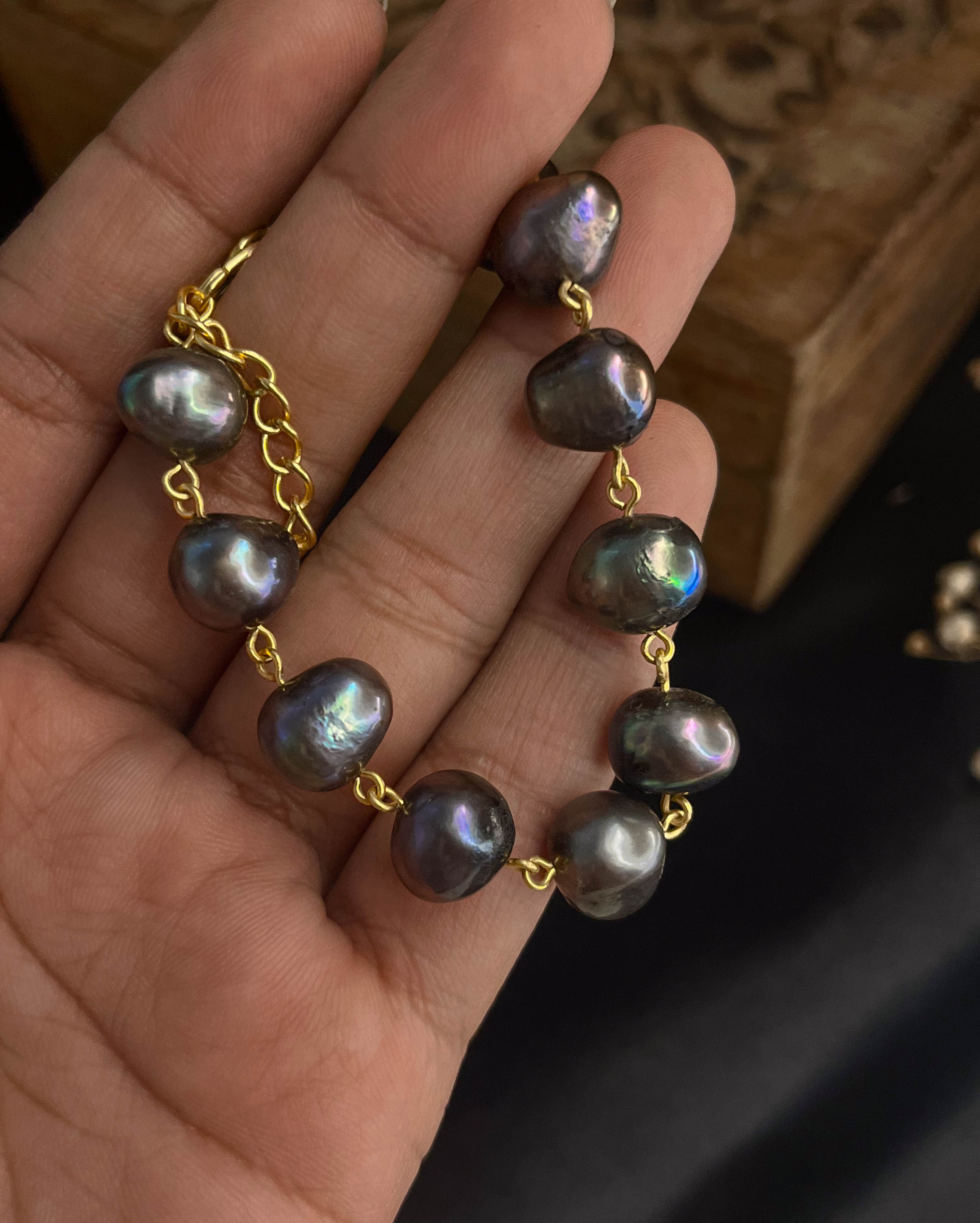 lustrous Black freshwater Pearl bracelet with gold plated chain and links handmade by A Creator's Studio
