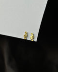 Brass musical note-shaped stud earrings handmade by A Creator's Studio
