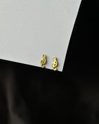 Brass musical note-shaped stud earrings handmade by A Creator's Studio