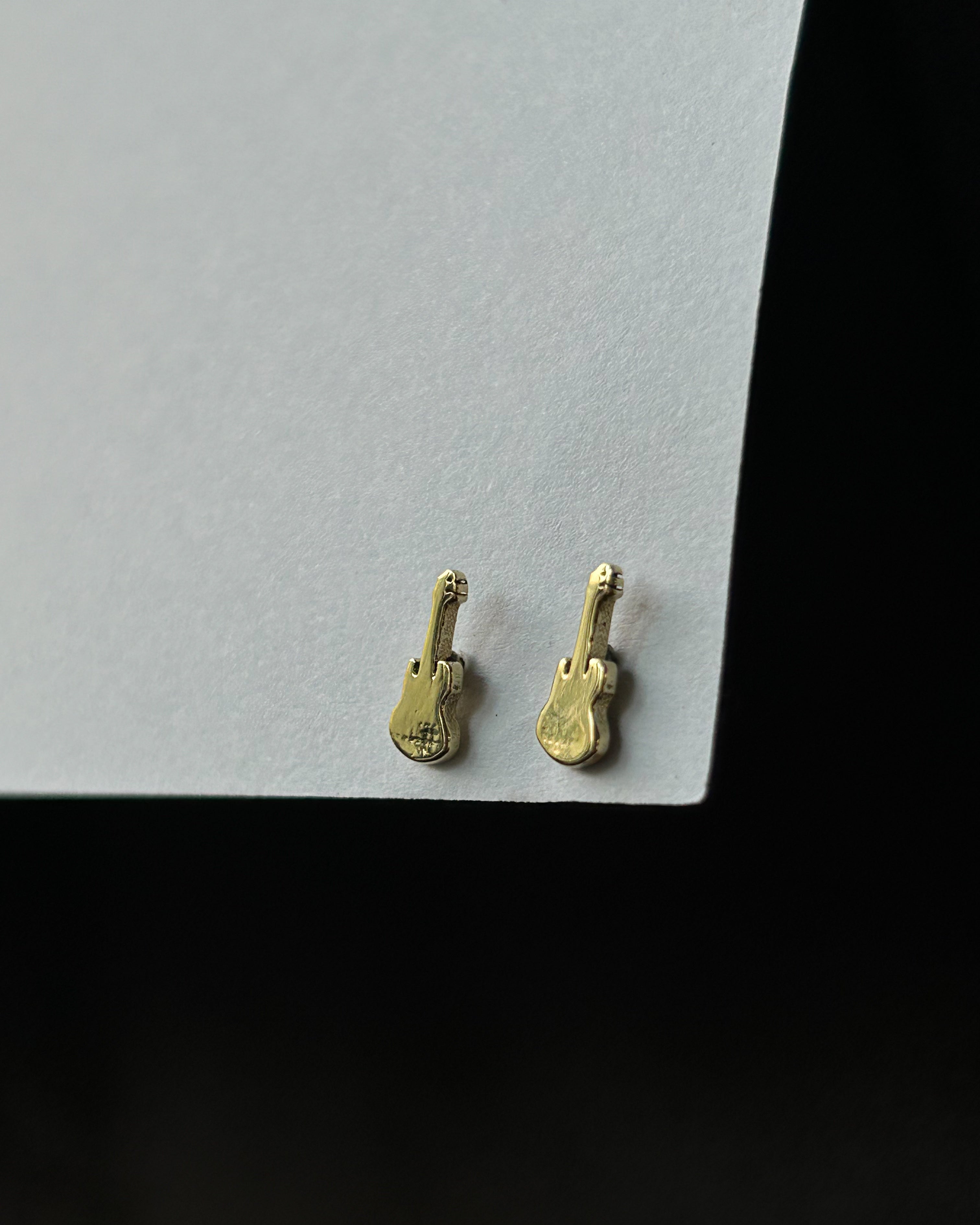 Brass guitar-shaped stud earrings handmade by A Creator's Studio