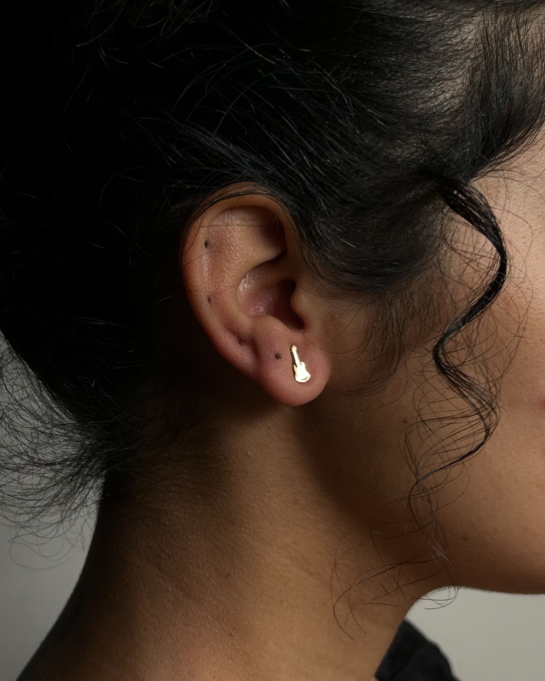 Brass guitar-shaped stud earrings handmade by A Creator's Studio