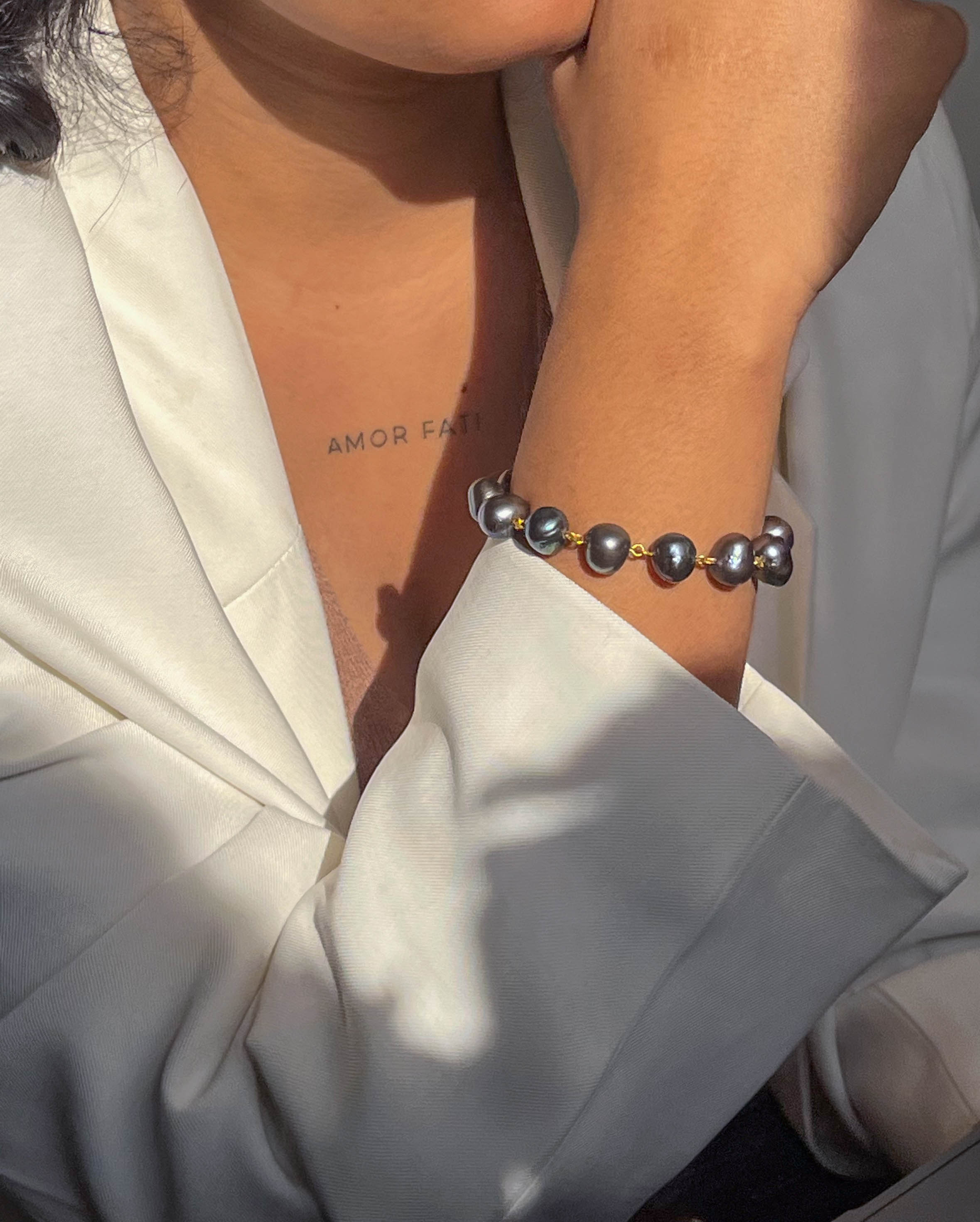 lustrous Black freshwater Pearl bracelet with gold plated chain and links handmade by A Creator's Studio