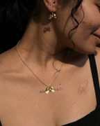 gold plated bow necklace with a bow pendant and matching earrings handcrafted by A Creator's Studio