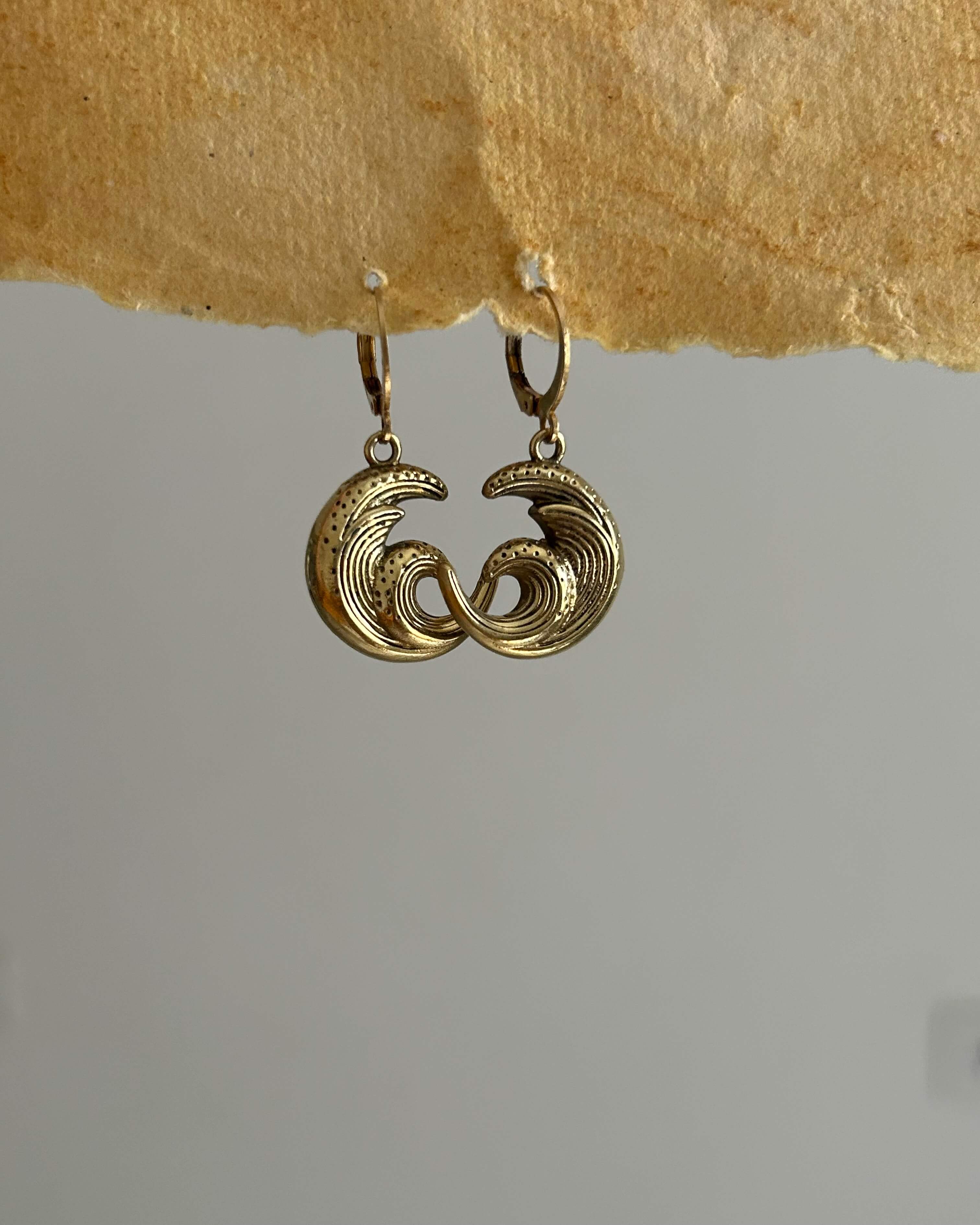 Brass earrings with unique sea wave design handmade by A Creator's Studio