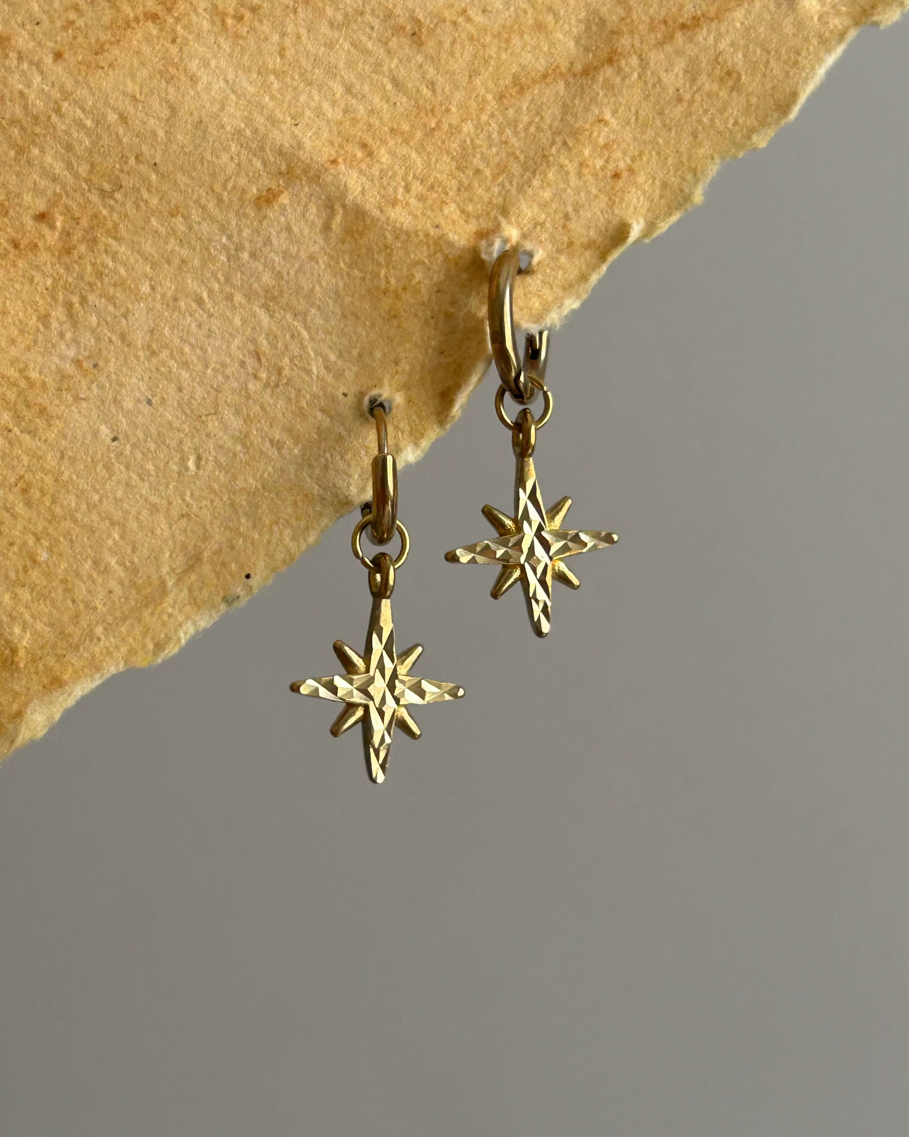 Brass earrings with unique star design handmade by A Creator's Studio