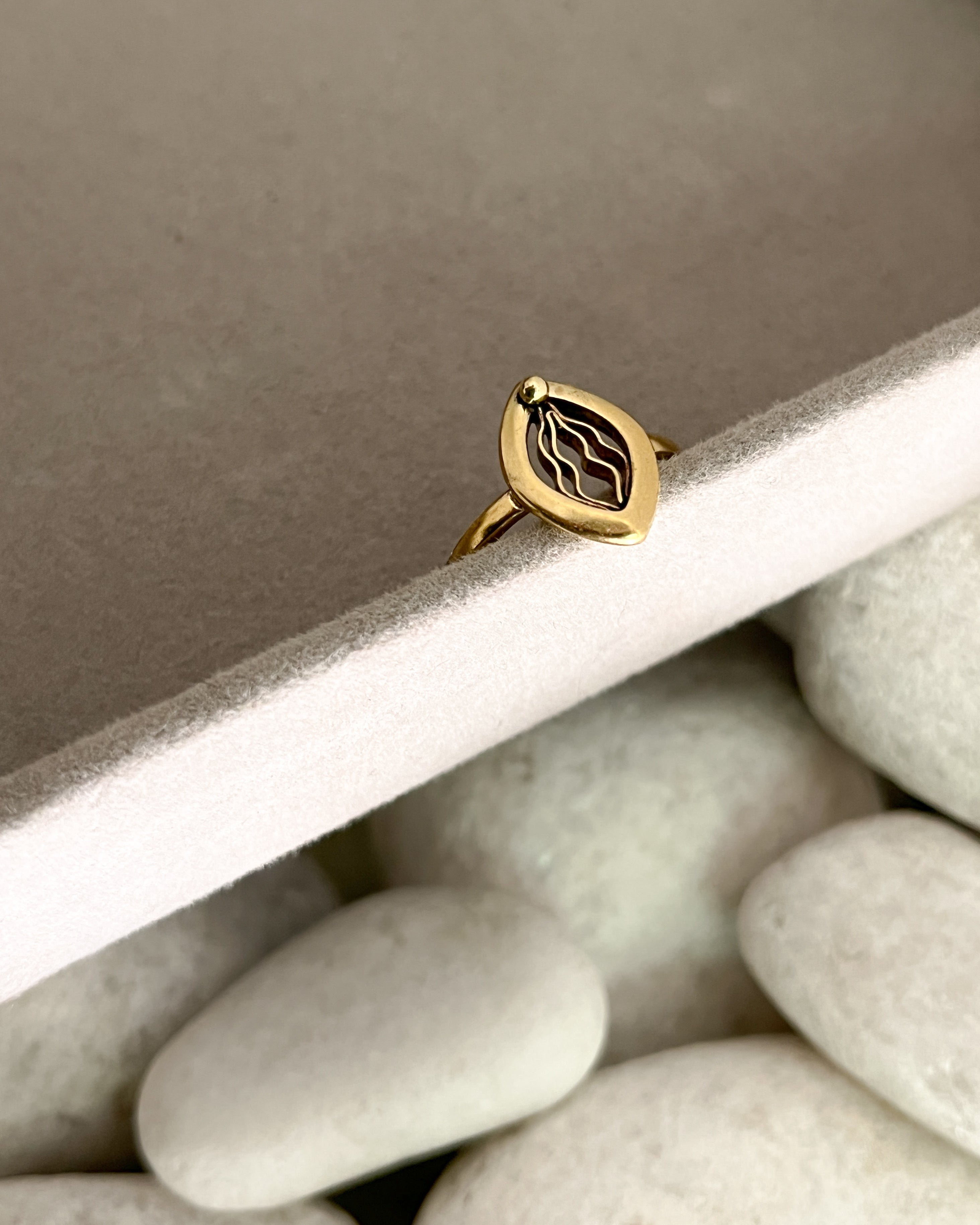 Brass ring with a unique vulva/yoni design handmade by A Creator's Studio