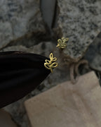 Brass leaf-shaped stud earrings handmade by A Creator's Studio