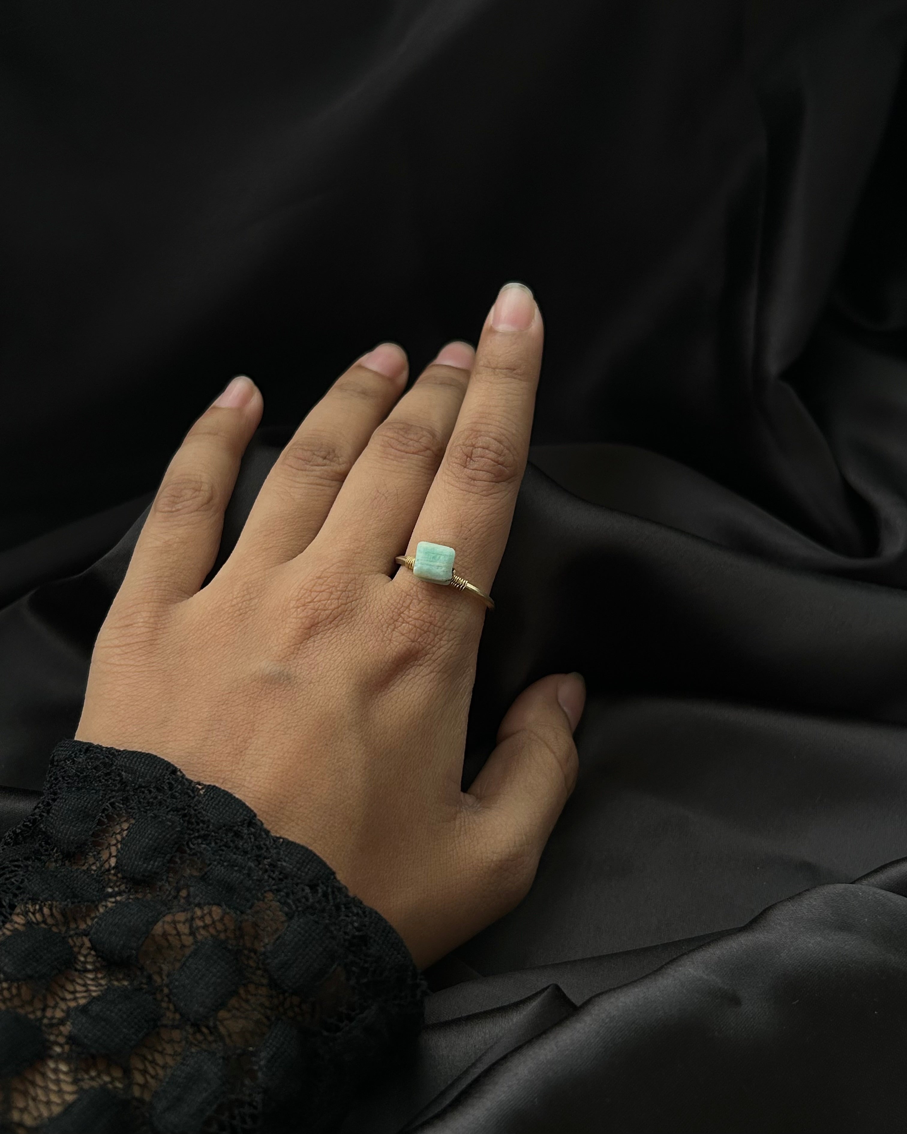 Brass ring with a unique larimar crystal design handmade by A Creator's Studio